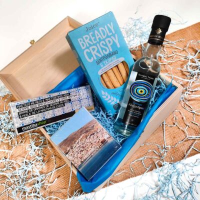 Summer gift with tsipouro, Turkish delight, mastic and breadcrumbs on a blue background