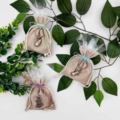 Favor pouch with hanging metal keyring in baby bottle or frog