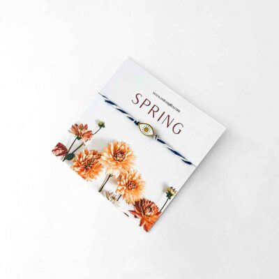 μαρτάκι a bracelet on a white surface