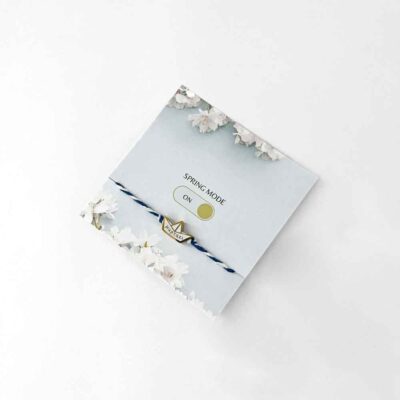 μαρτάκι a blue and white bracelet with a gold charm on it