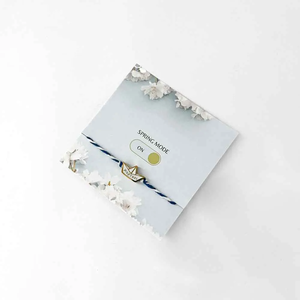 μαρτάκι a blue and white bracelet with a gold charm on it