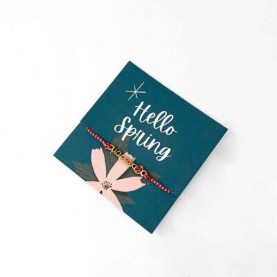 μαρτάκι a blue card with a bracelet on it