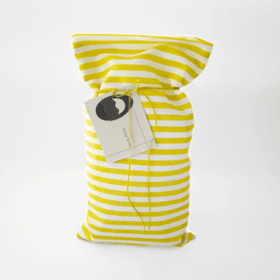 a yellow and white striped bag with a tag